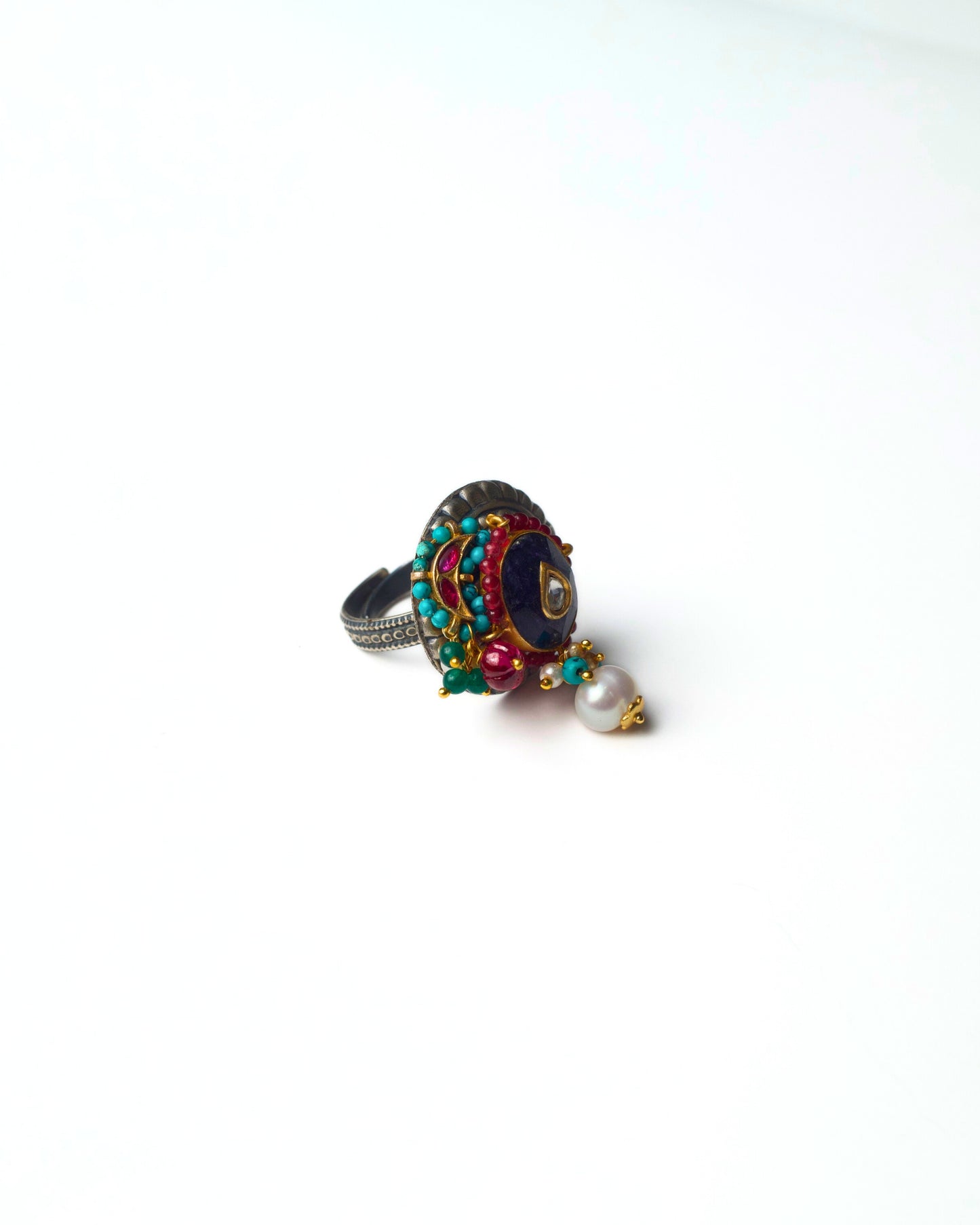 Side view of Indigo Core Ring crafted in 925 silver showing raised bezel structure, layered depth, and clustered accent work.