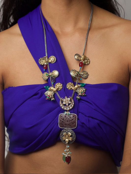 Close-up of Naksa’s Silsila Long Necklace handcrafted in 92.5 silver with elephant, moon, and gemstone motifs in a layered tribal-inspired design.