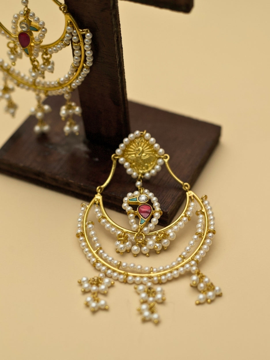 Nazaara Jhumkas by Naksa—gold polished 925 silver earrings with layered pearl crescents, kundan detailing, and a central parrot motif.