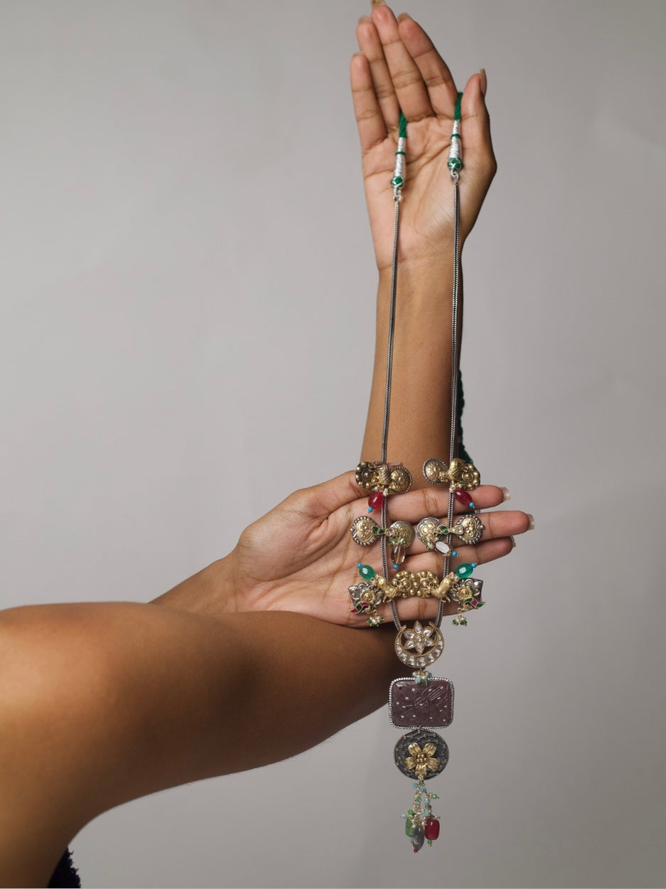 Close-up of Naksa’s Silsila Long Necklace handcrafted in 92.5 silver with elephant, moon, and gemstone motifs in a layered tribal-inspired design.