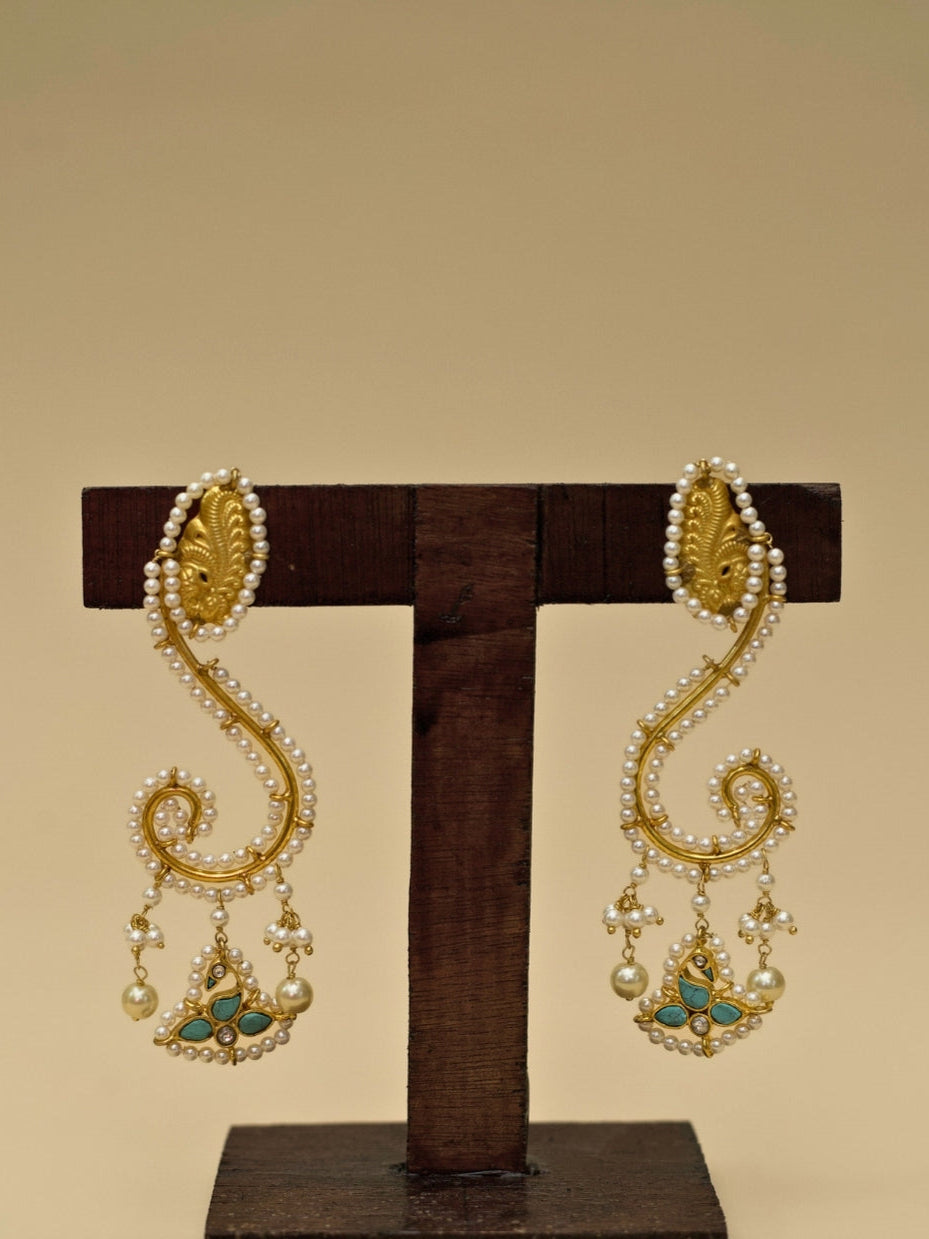 Ghunghat Jhumkas by Naksa—sculptural 925 silver earrings with pearl-lined curve, kundan bird drop, and gold polish.