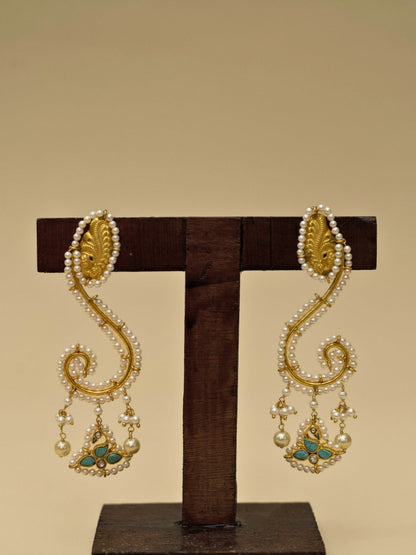 Ghunghat Jhumkas by Naksa—sculptural 925 silver earrings with pearl-lined curve, kundan bird drop, and gold polish.