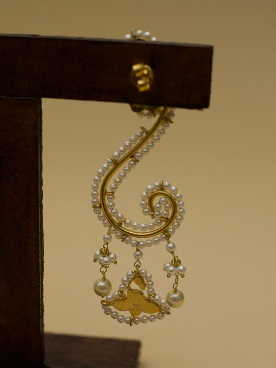 Ghunghat Jhumkas by Naksa—sculptural 925 silver earrings with pearl-lined curve, kundan bird drop, and gold polish.