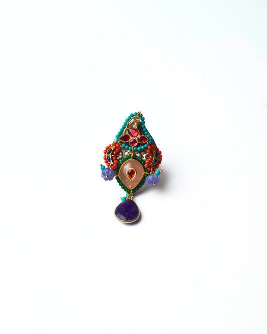 Silver ring with triangular shrine-style structure, kundan-set teardrop center, layered beadwork, and a suspended drop at the base