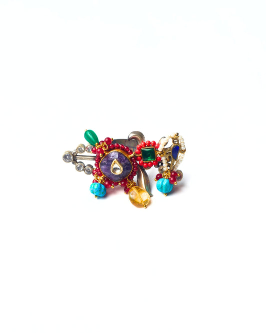 The Wingline Ring front view in 925 silver, horizontal statement ring with central kundan stone, red and turquoise beads, gemstone drops, and layered metal detailing