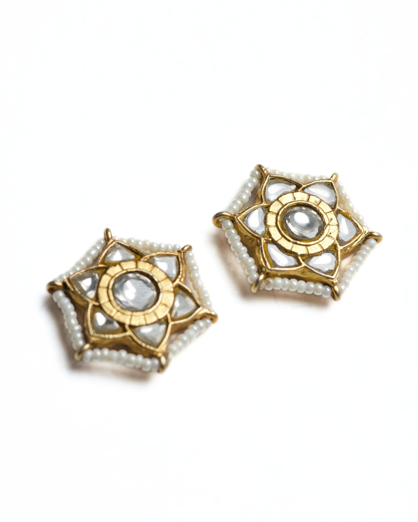 Gold-polished silver sunburst studs with central stone detail