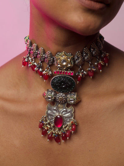 Close-up of The Garland Choker in 92.5 silver with red beads, temple-inspired details, and intricate golden accents