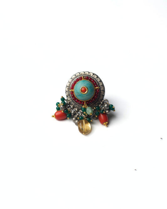 Turquoise Halo Ring in 925 silver with turquoise centre, coral core, red bead detailing, and dangling stone accents