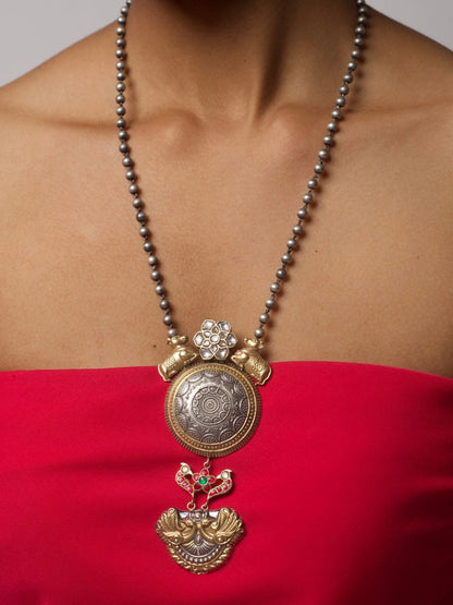 Close-up of handcrafted 92.5 silver necklace with cow and peacock motifs, floral accents, and antique-finished beads