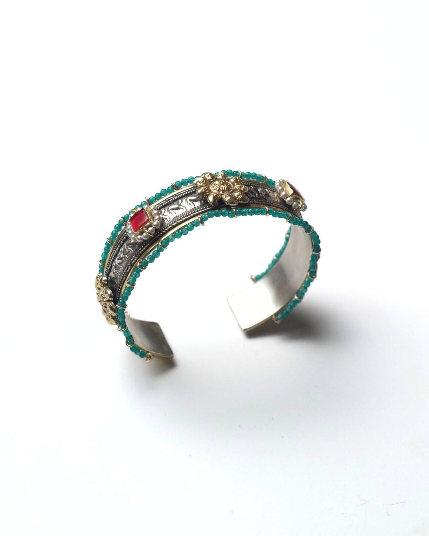 Side view of The Floral Desert Bangle showcasing layered silver detailing, turquoise bead edging, and raised floral elements in 925 silver