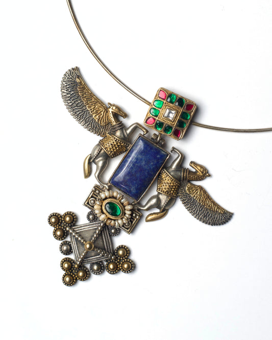 Close-up of lapis stone centre with winged silver guardians, kundan accents, and layered metal detailing on hasli necklace