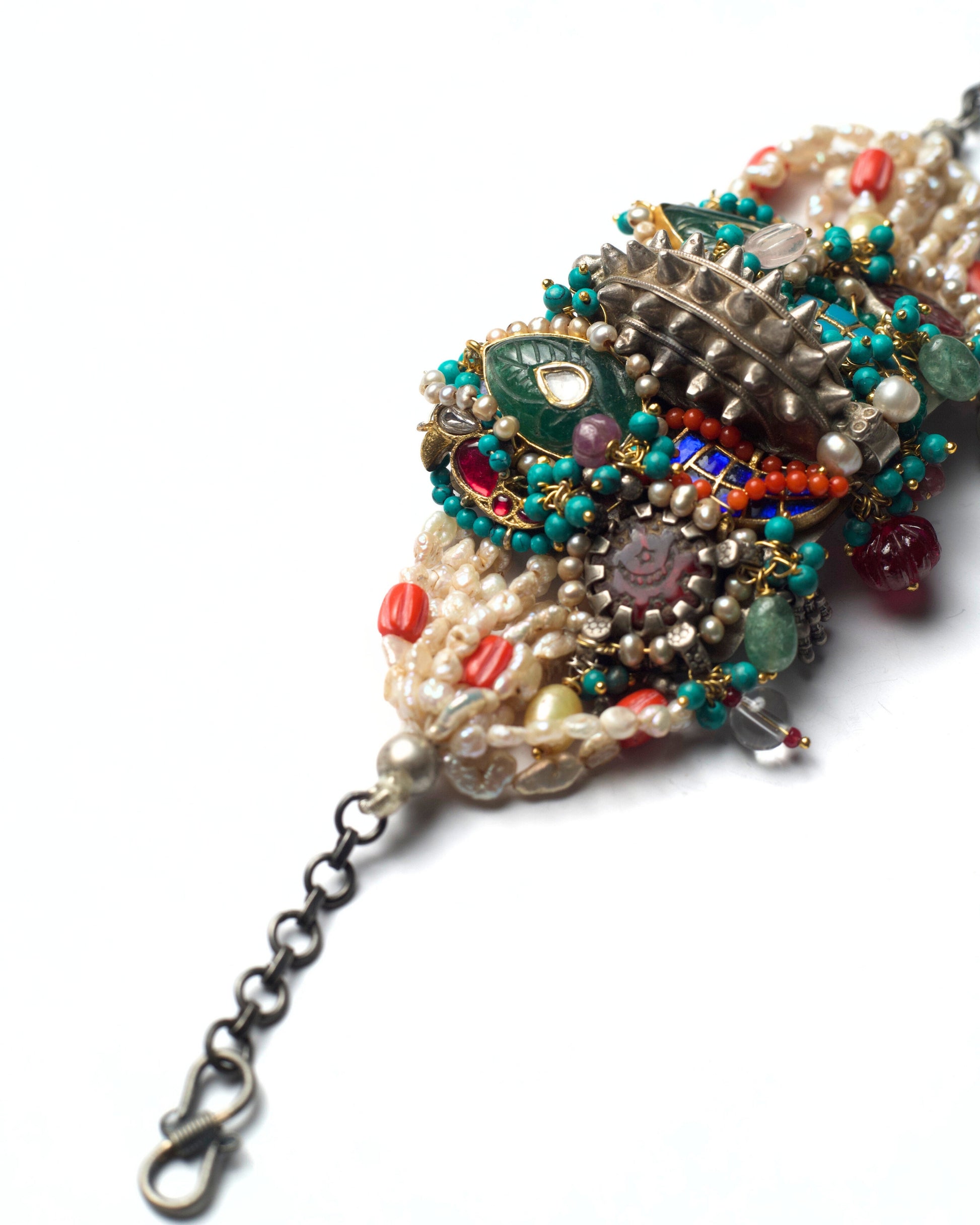 Side view of Central Relic convertible bracelet showcasing layered pearl rows, turquoise accents, and gold-polished kundan settings