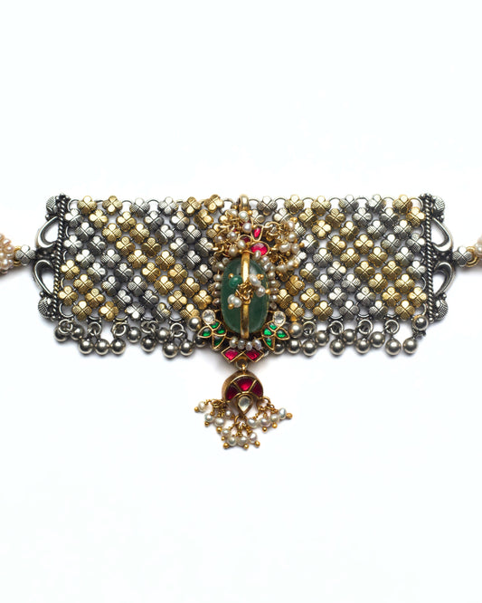 Dual-tone silver jaali choker with central green stone and pink kundan droplet detailing