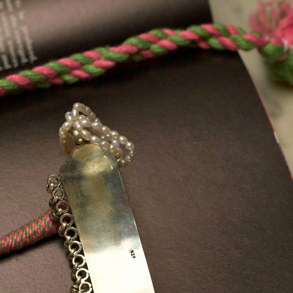 Light in weight but heavy on details, this piece creates the perfect balance by combining the dark patina of oxidised silver with pearly whites. The embossed and pastel-coloured flowers are a visual feast accentuated by the dangling ghunghroo beads. Style this with any outfit and flaunt your true spirit.&nbsp;
