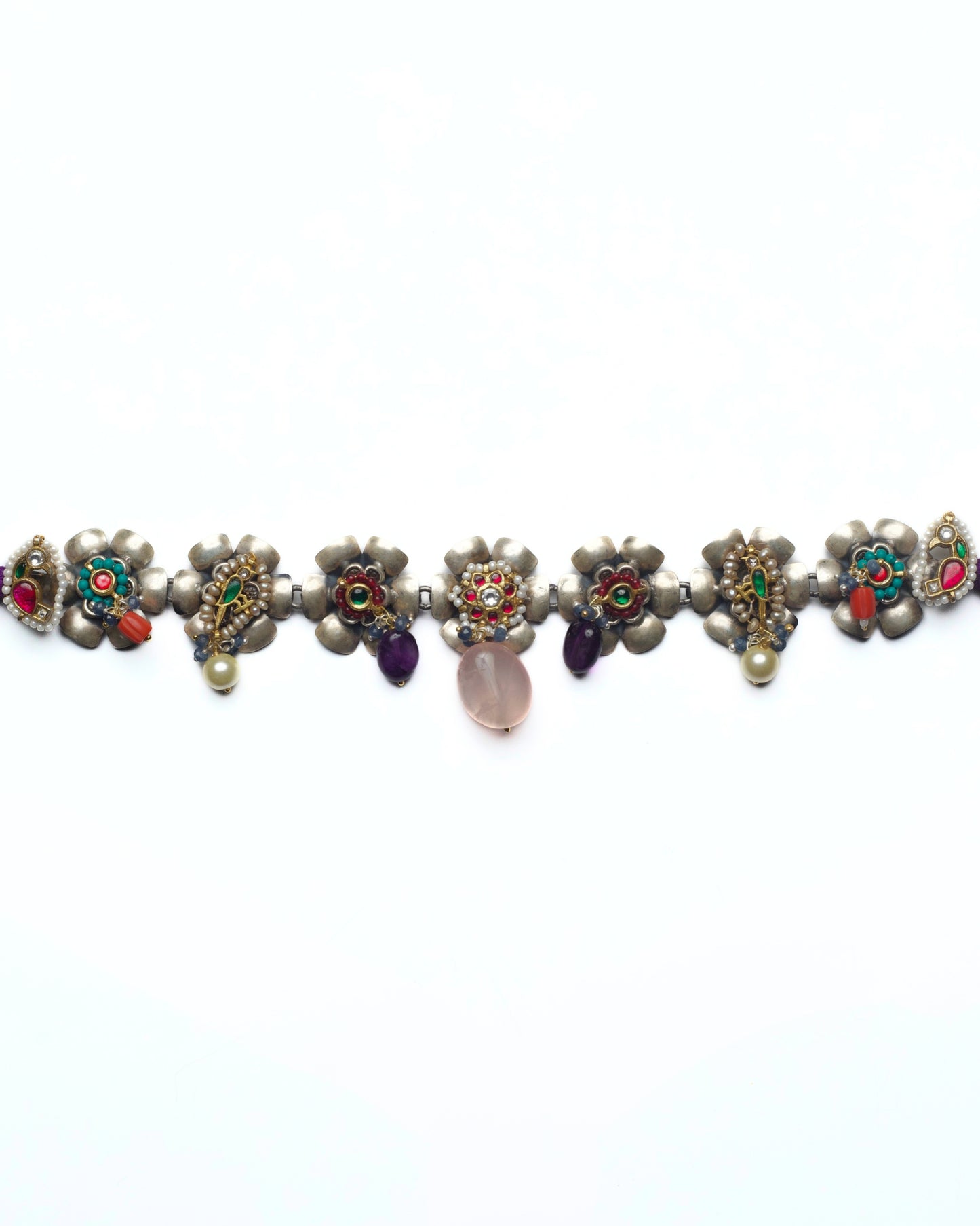 Floral silver choker with kundan-set flower centres and pink stone drops arranged in a linear row