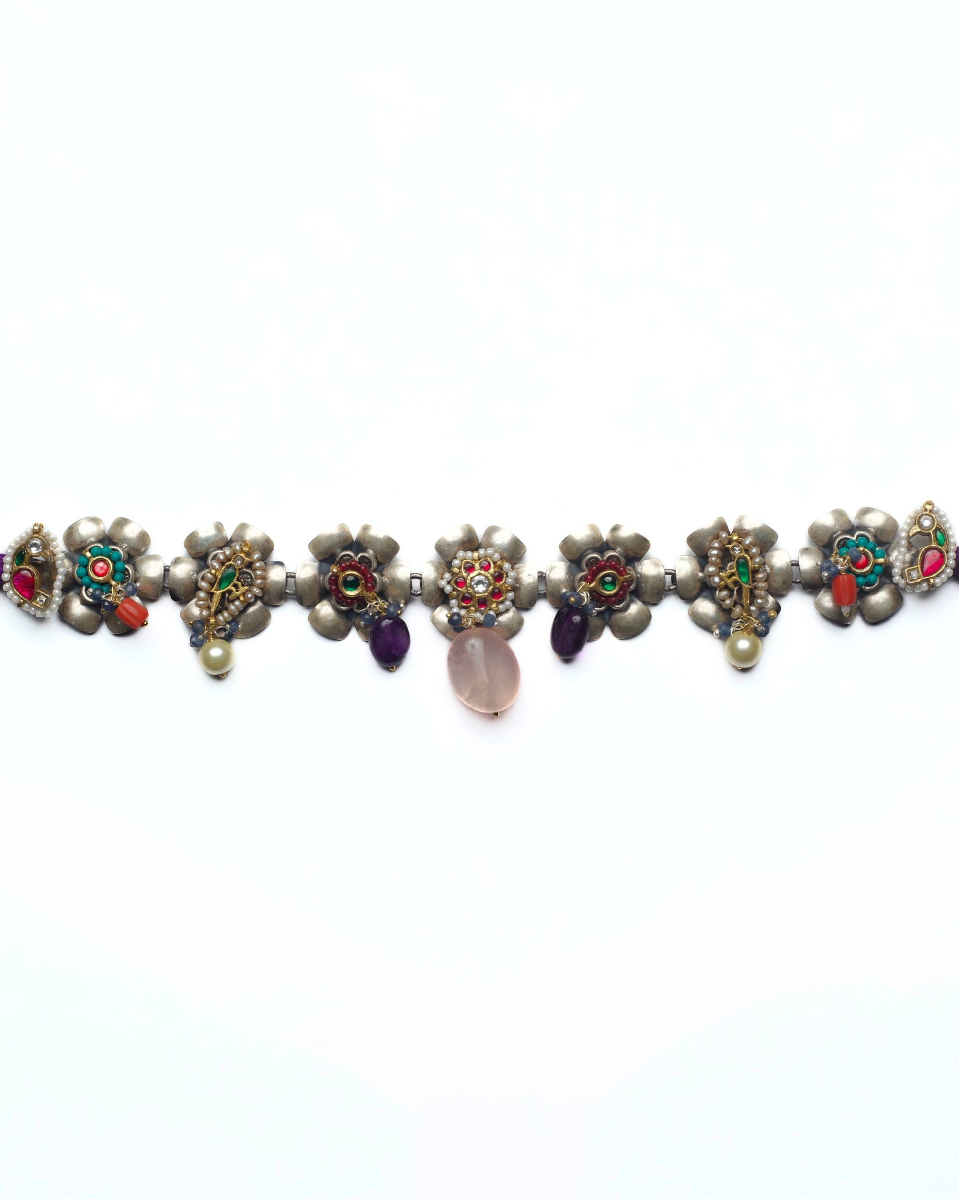 Floral silver choker with kundan-set flower centres and pink stone drops arranged in a linear row