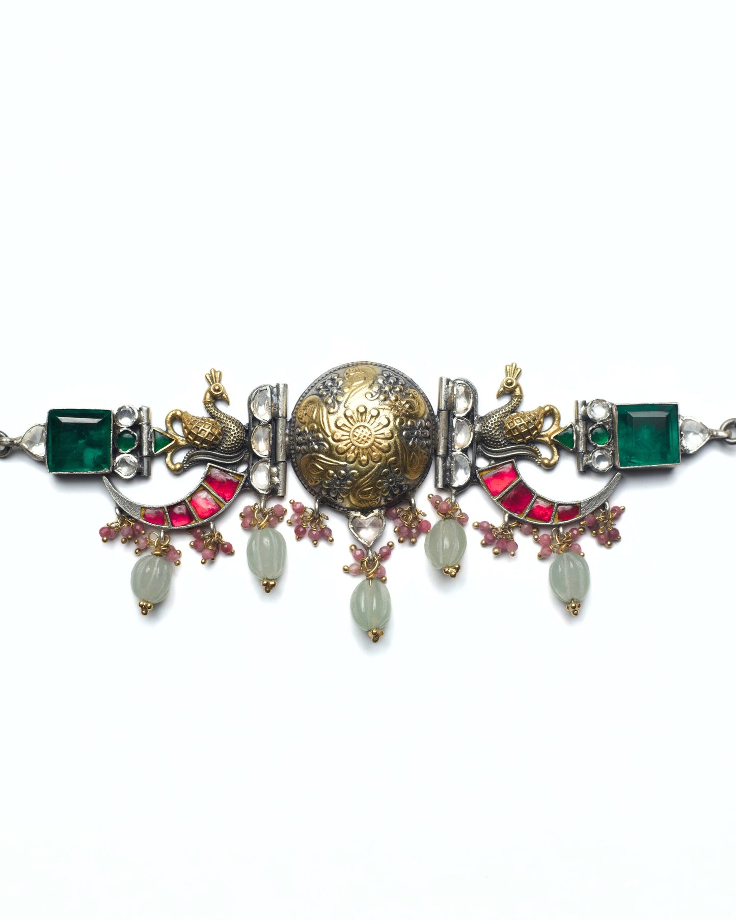 The Peacock Halo Choker in 925 silver featuring a dual-tone central medallion, sculpted peacock motifs, green stone highlights, pink stone arcs, and carved stone drops.