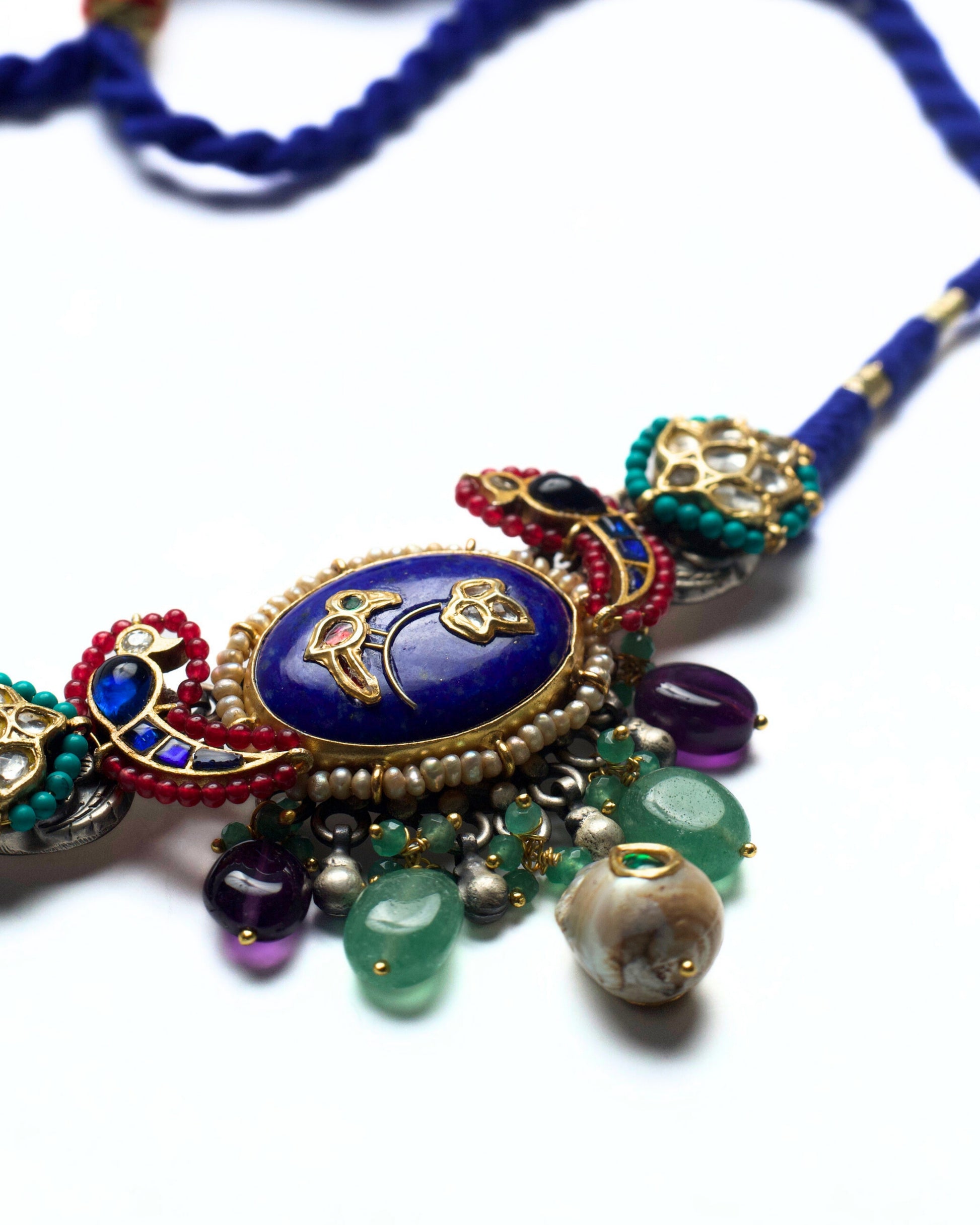 Close-up of lapis stone choker with kundan florals and pearl drops