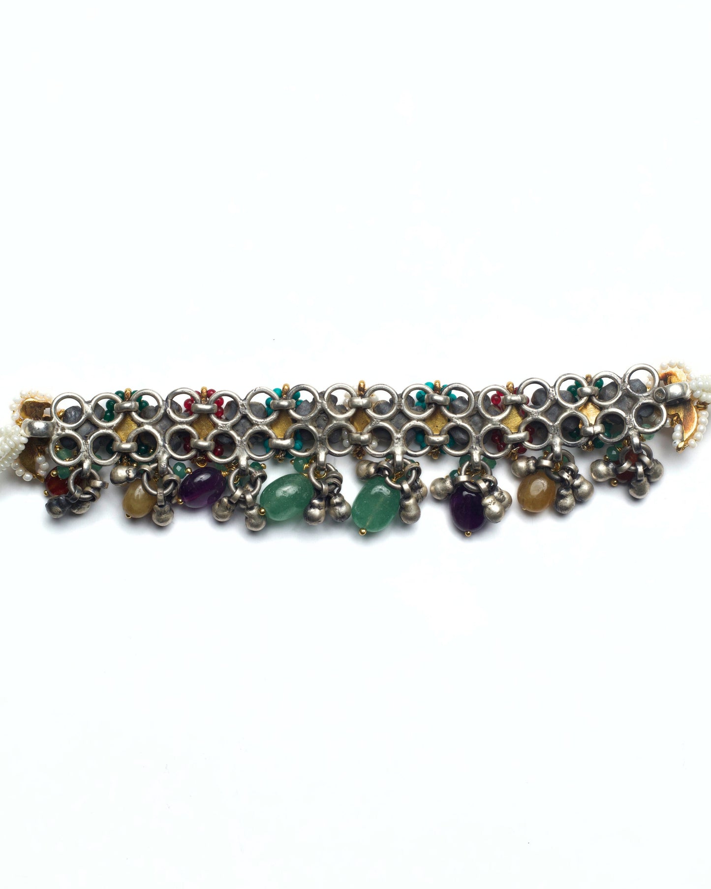 Back of oxidised silver rosette motifs with teardrop-shaped ruby red and emerald green kundan settings