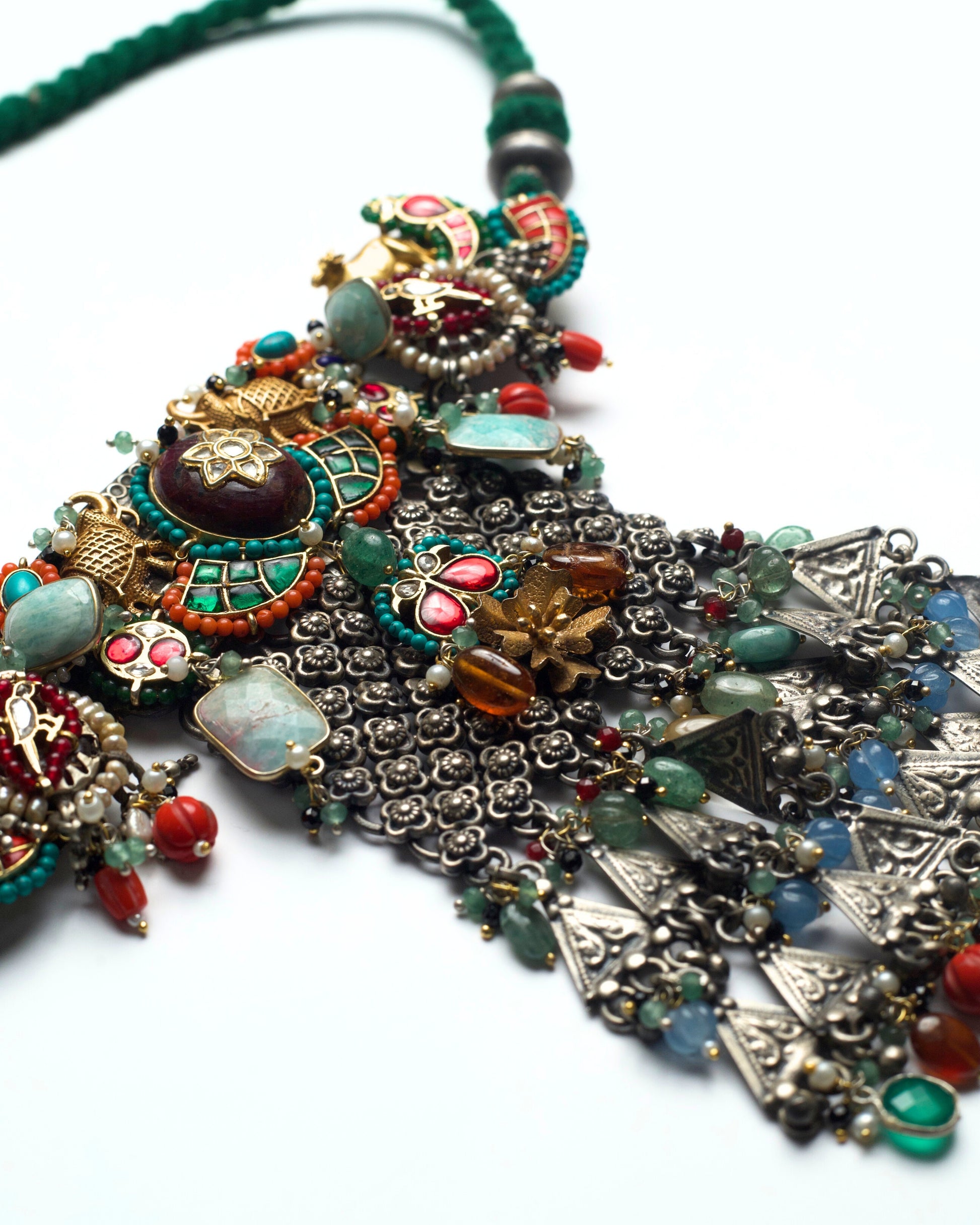 Oxidised silver lattice work with embedded multicoloured stone settings forming the central body of the choker