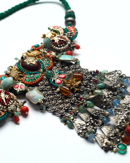 Oxidised silver lattice work with embedded multicoloured stone settings forming the central body of the choker