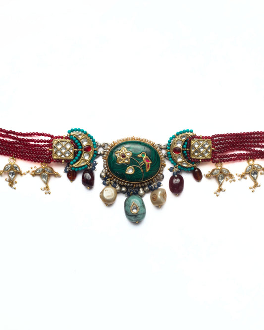Handcrafted kundan choker featuring crescent moon details, square grid settings and green stone centre