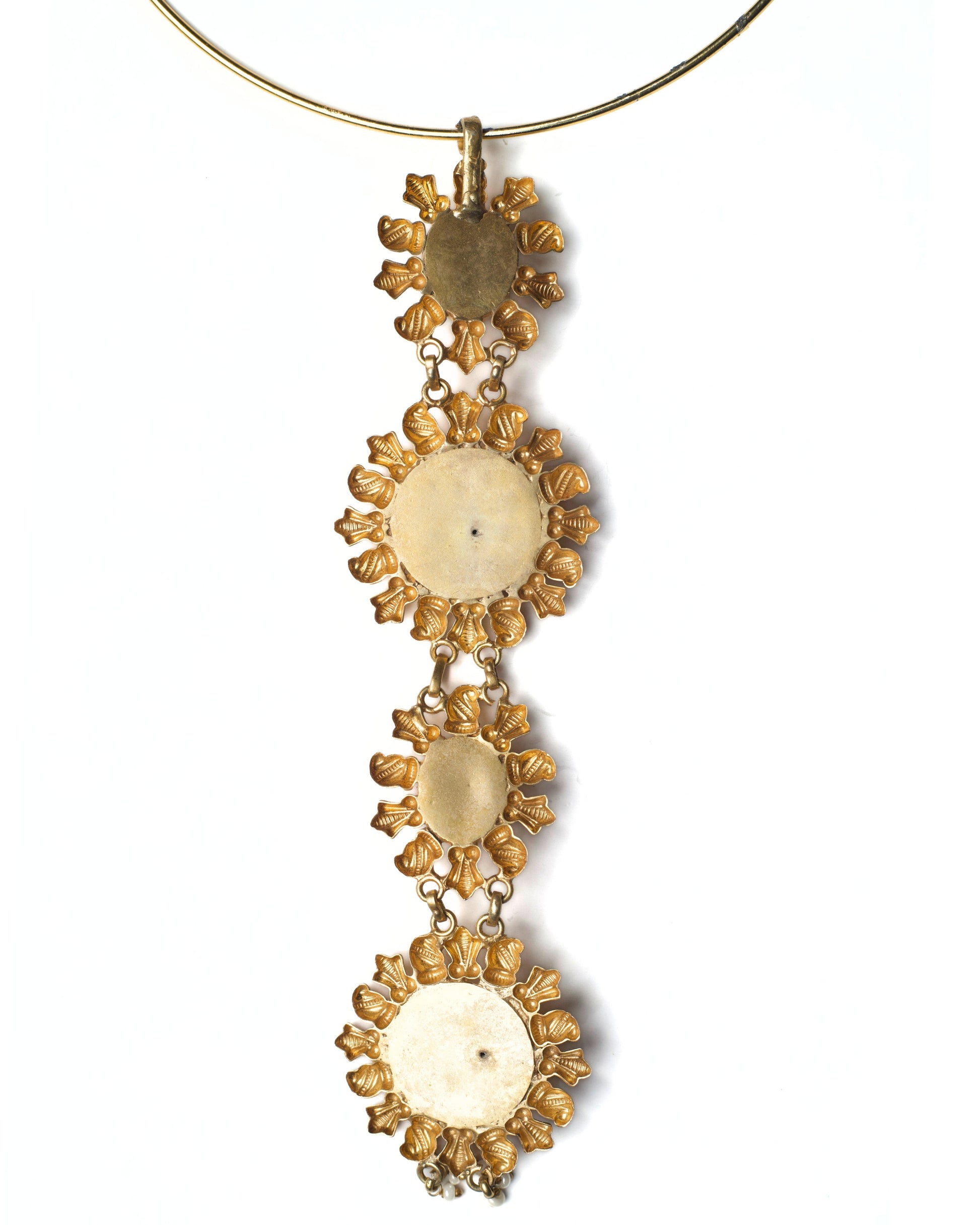 Back view of rigid gold-toned hasli showing smooth circular band and drop attachment