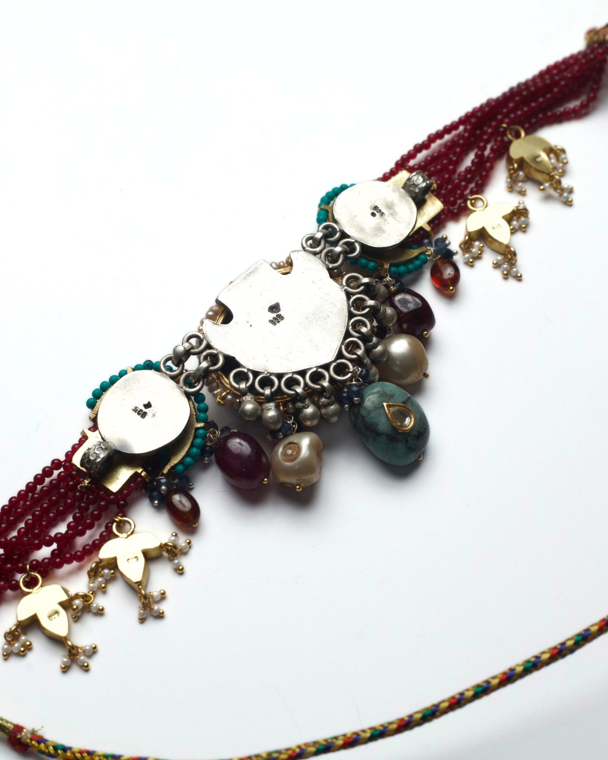 Back of statement silver choker with red beading, crescent motifs, kundan work and pearl stone drops