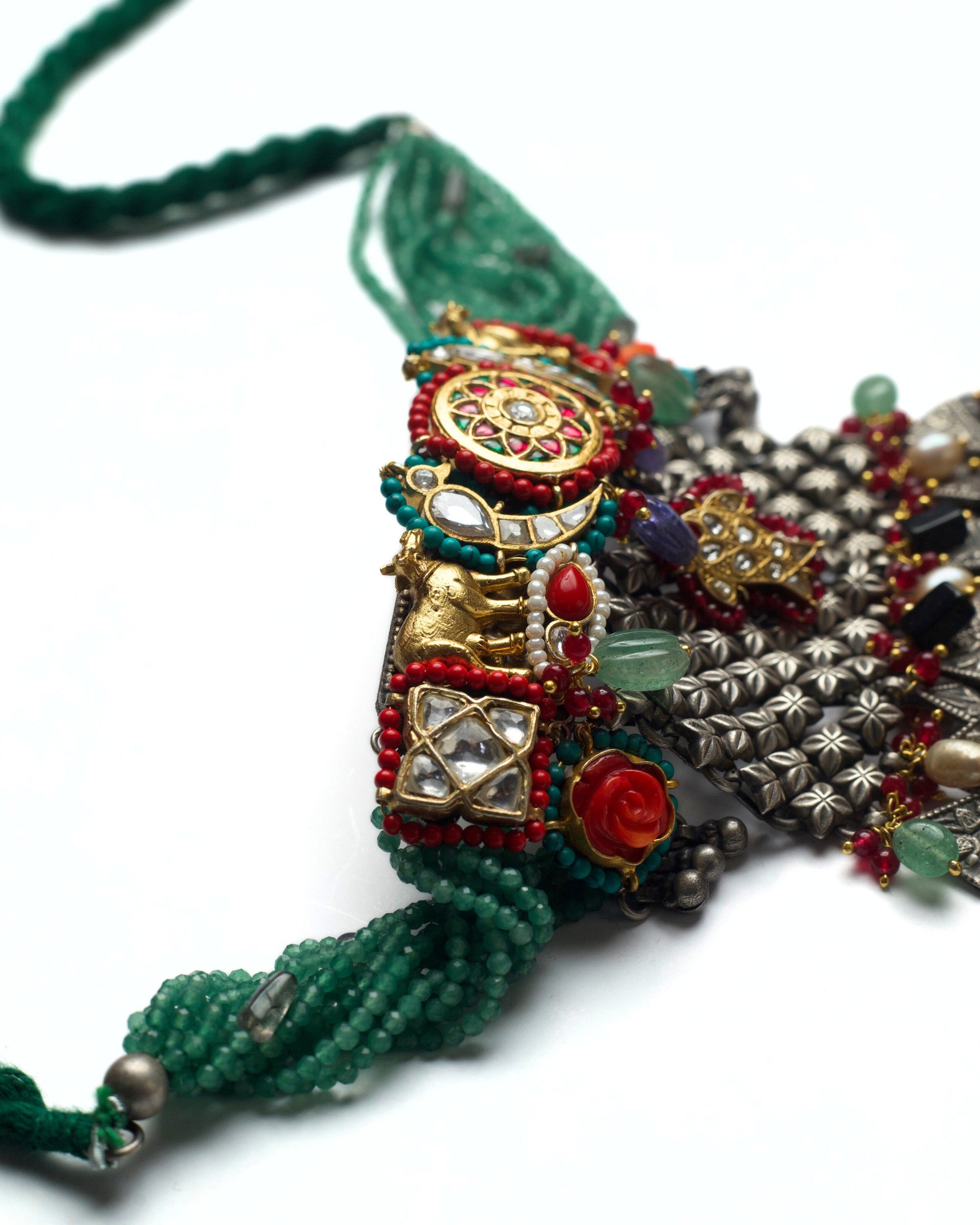 Top panel of fusion choker featuring floral kundan centre, parrot motifs, grid detailing, and orange turquoise accents in oxidised silver
