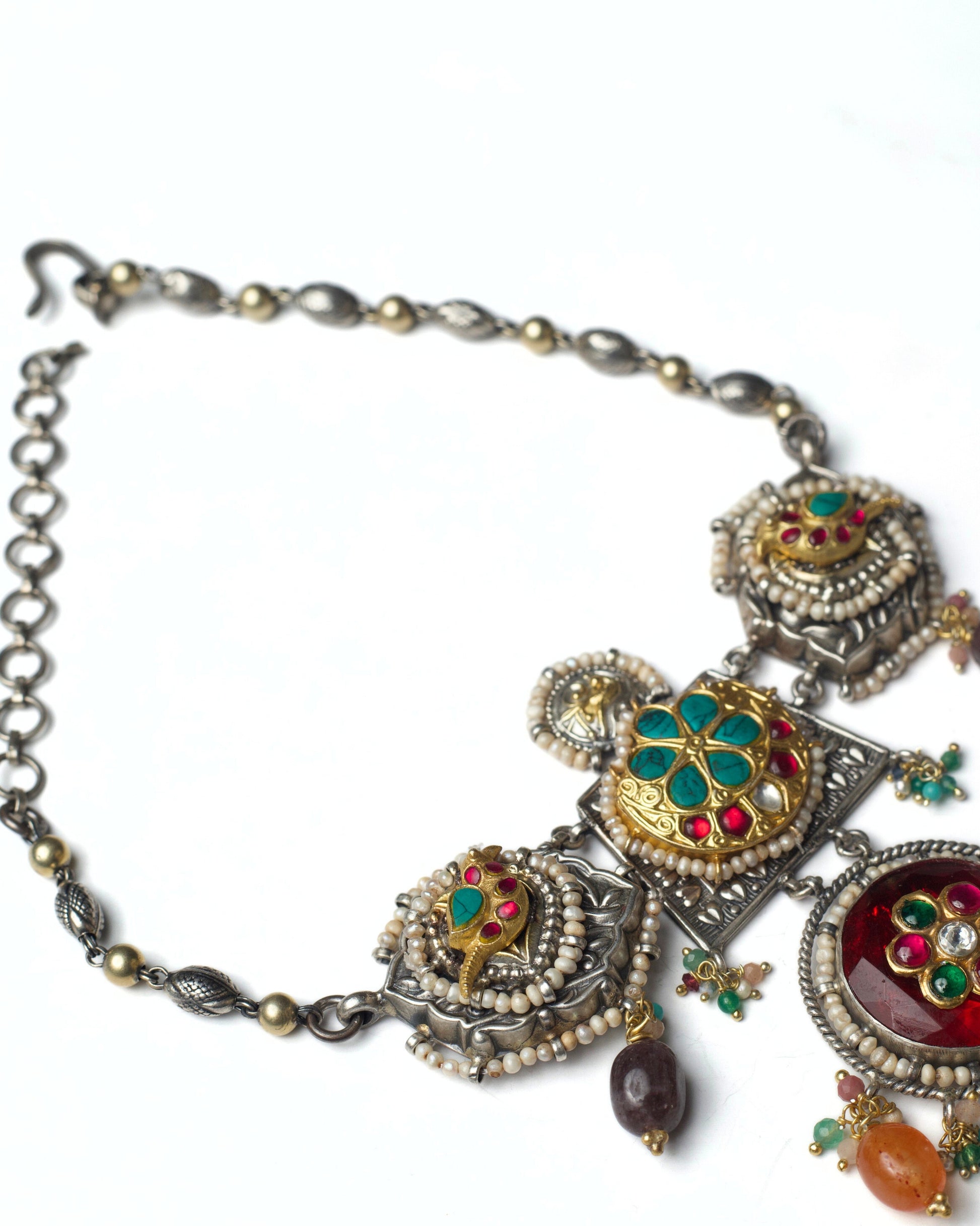 Oxidised silver panels with kundan flowers and parrot motifs bordered with pearls