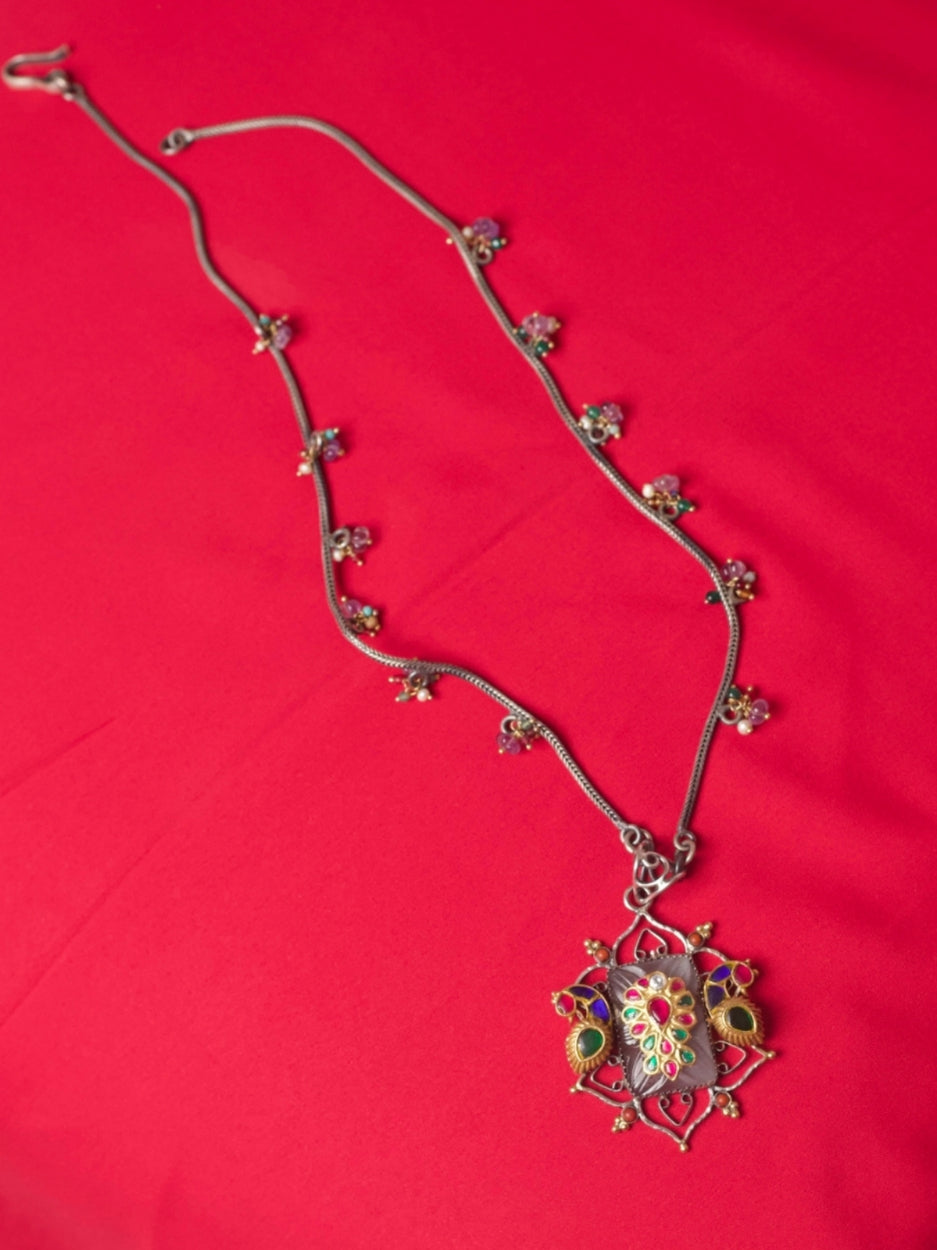 Pure silver necklace with carved salmon gemstone, kundan navratna detailing, gold parrots and bead accents