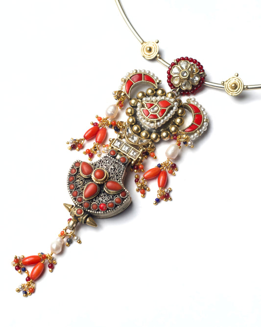 Close-up of Fire Altar Hasli pendant highlighting orange stones, kundan work, pearls, and oxidized silver texture