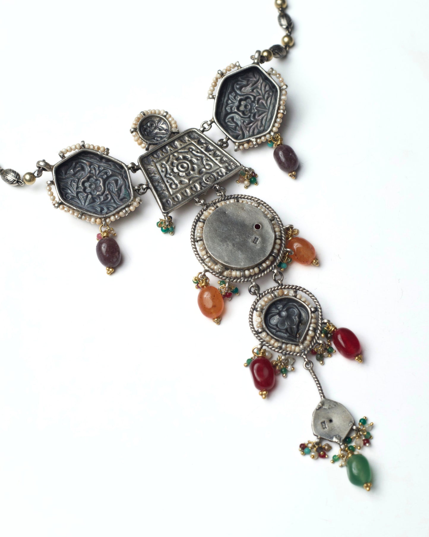 Back view of red stacked heirloom necklace choker in oxidised silver with kundan floral motifs, pearl borders, parrot details, and multicolour stone drops