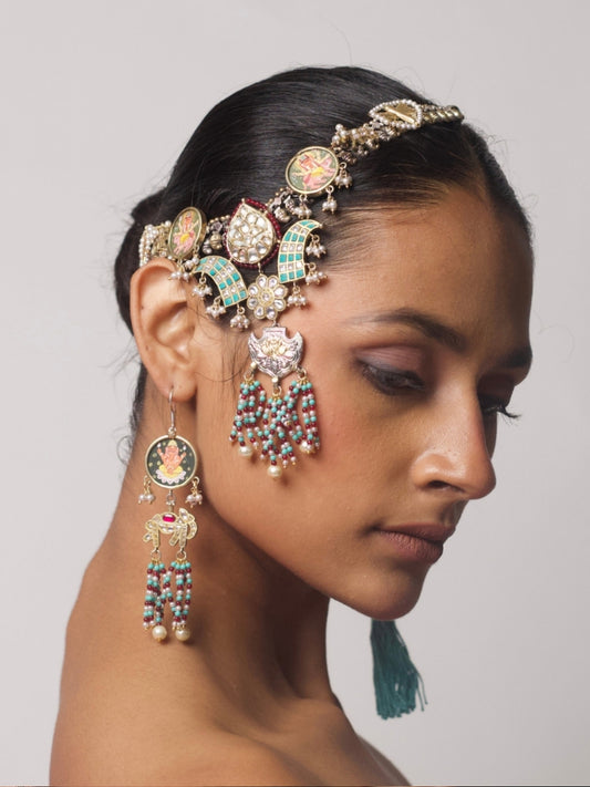 Model wearing The Divine Contradictions Set – a pure silver headpiece and earring set featuring hand-painted deity motifs, kundan detailing, and pearl bead tassels.