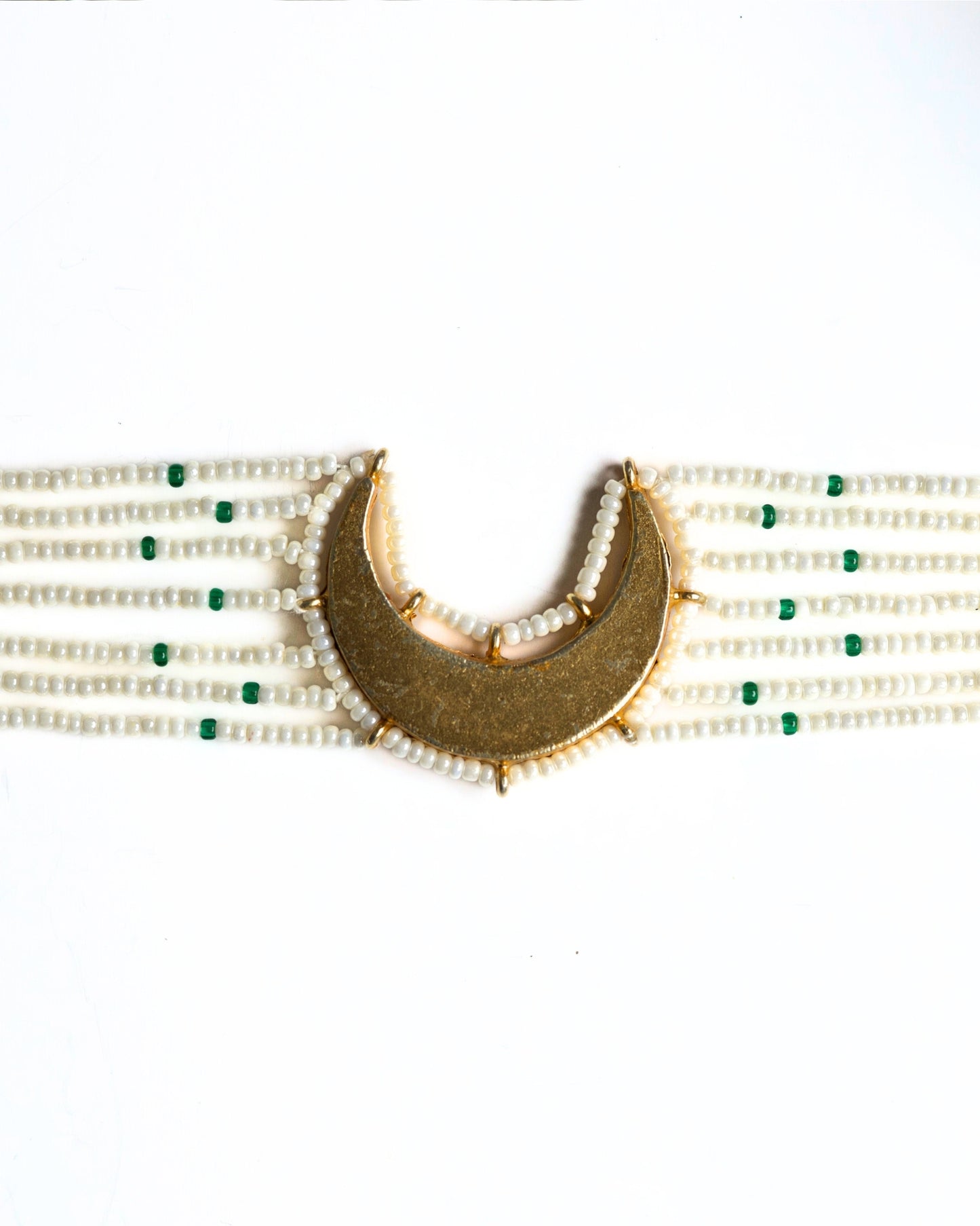 Close-up of pearl choker with green accents and kundan-style stones