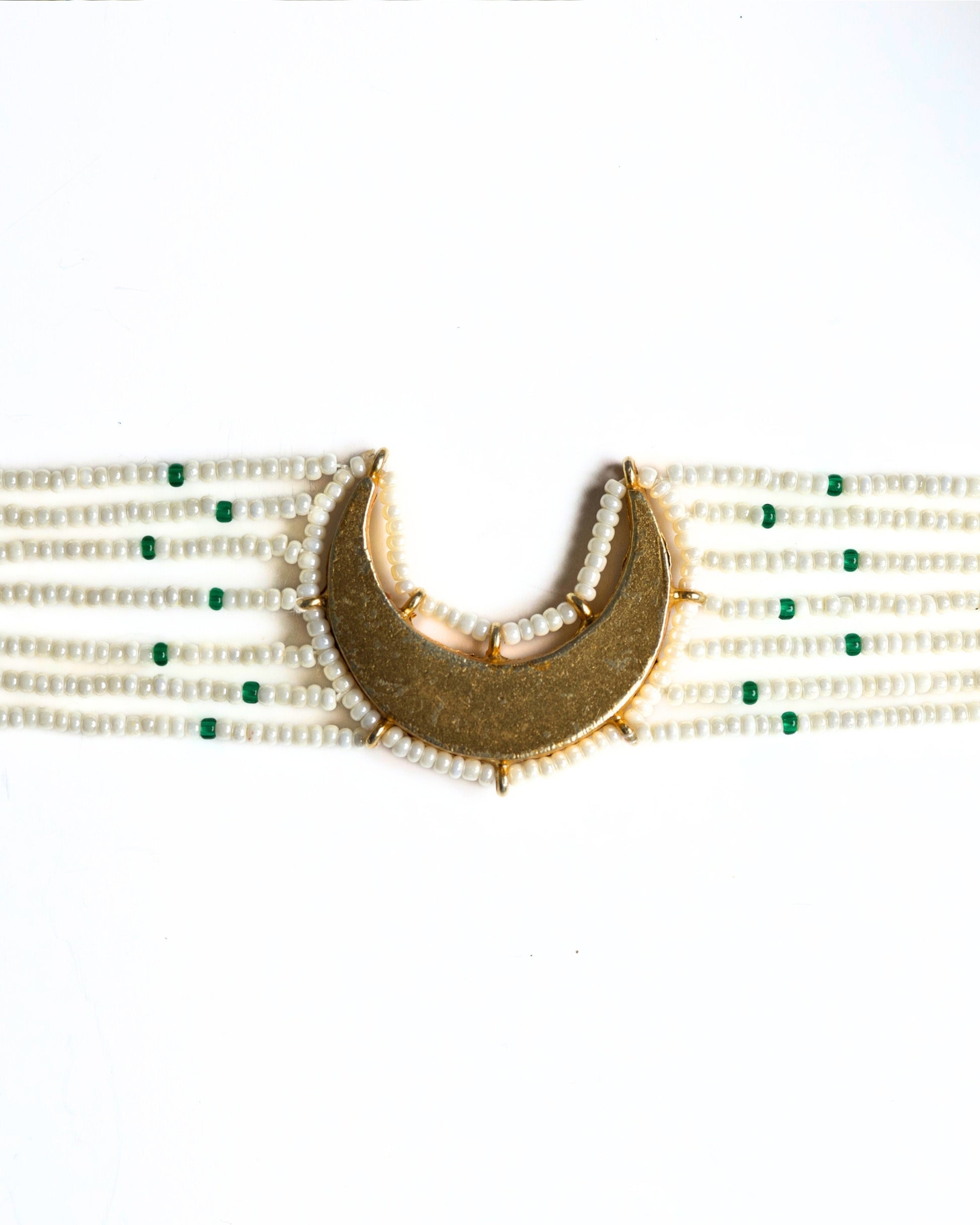 Close-up of pearl choker with green accents and kundan-style stones