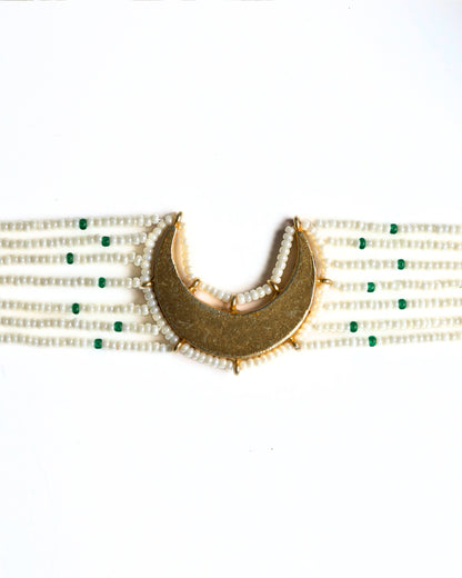 Close-up of pearl choker with green accents and kundan-style stones