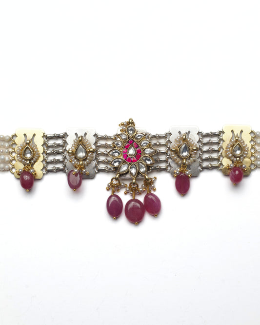 Oxidised silver kundan choker with floral rosette centre, pearl detailing, teardrop kundan accents, and ruby stone drops