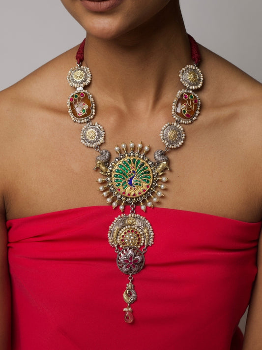 Close-up of Sheesh Mahal Necklace in 925 silver featuring central peacock enamel motif, side gold floral accents, and silver architectural drops.