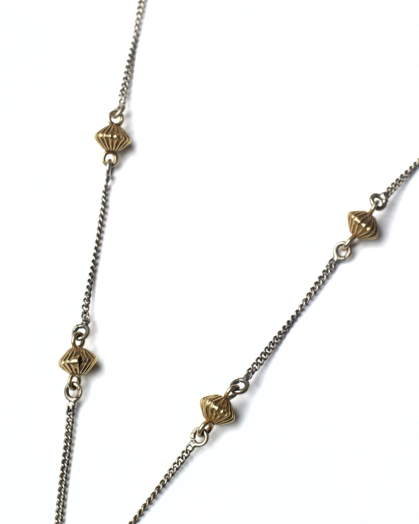 Fine silver chain with gold-toned accents on Parrot Arc Chain Necklace
