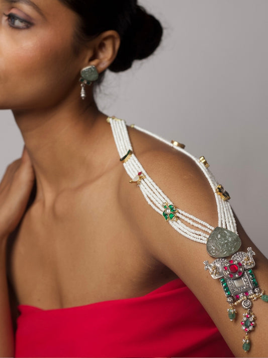 Five-strand Panchlada necklace in pure 92.5 silver with pearl beads, green carved stones, and a temple-style pendant featuring birds, moons, and intricate motifs. Styled with matching earrings.