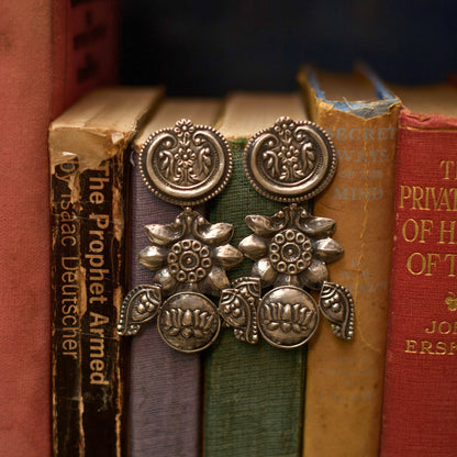 This extremely lightweight three-tier heritage silver earring features intricate flower embossing flanked by two carved fish. A perfect choice for everyday wear, this 925 pure oxidised silver earring sings the poetry of nature.