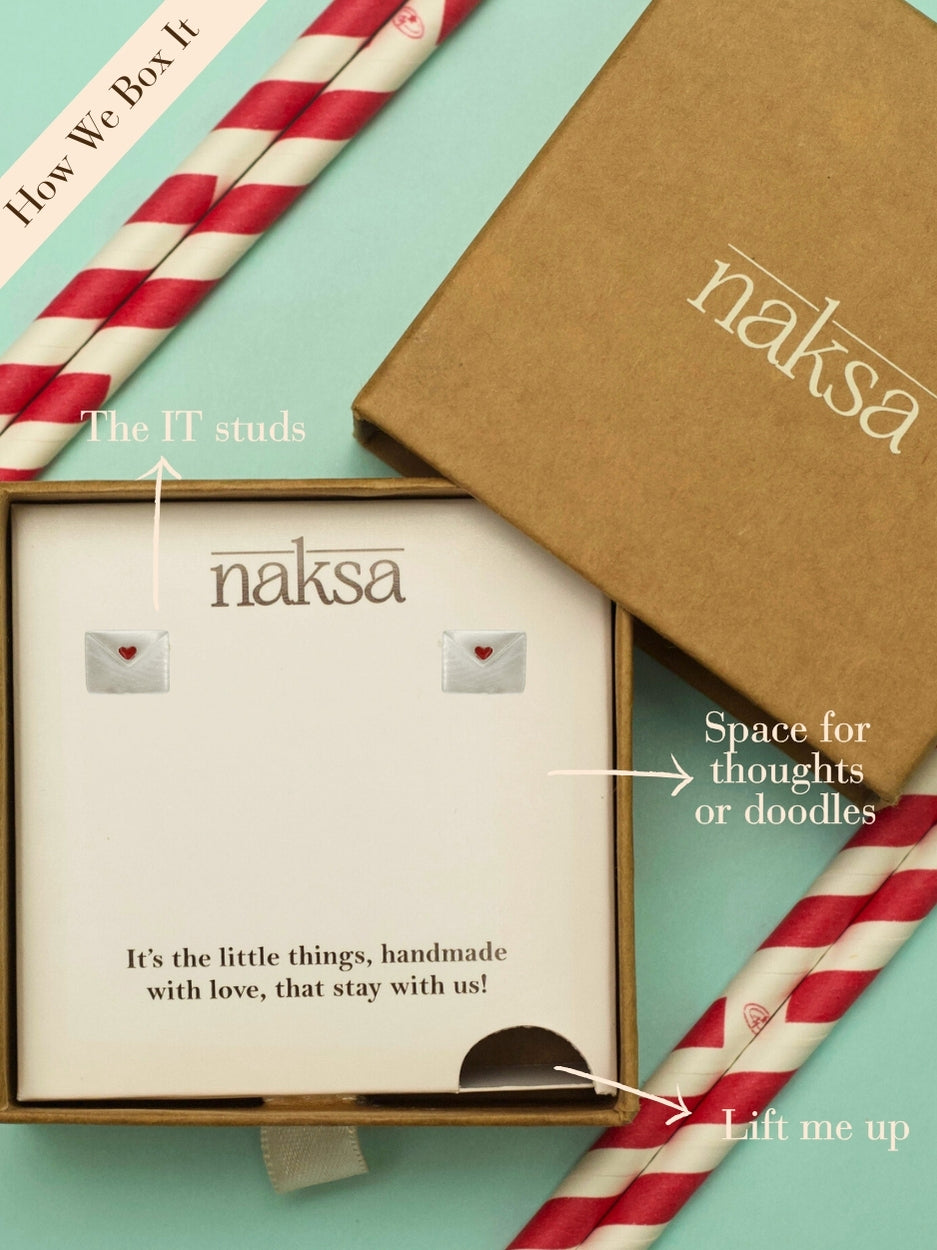 Tiny Love Note Studs by Naksa—mini silver envelope earrings sealed with a red heart, handcrafted in 925 silver.