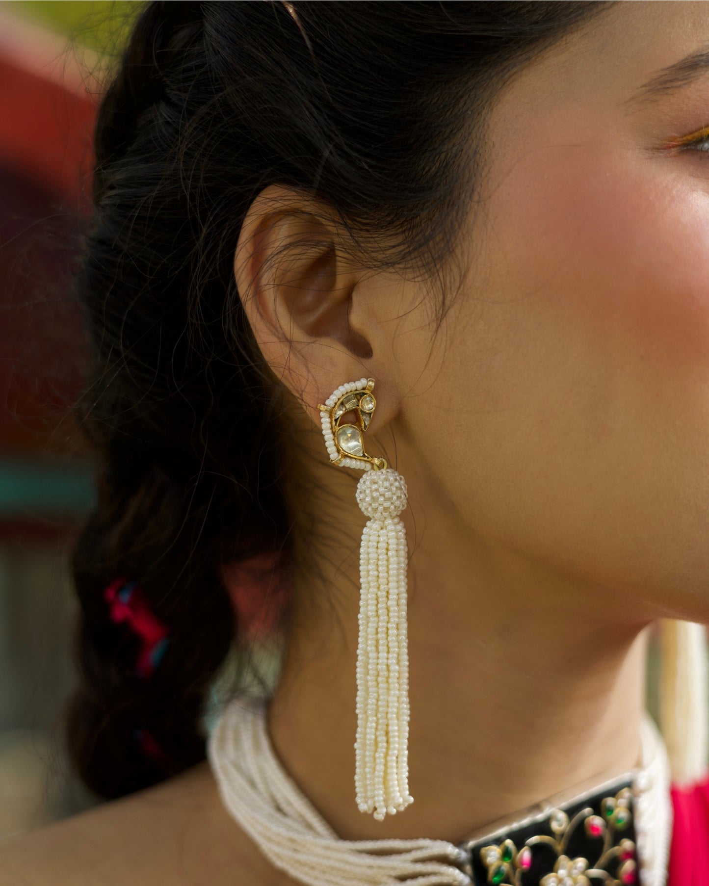 Gold-toned 925 silver bird earrings with kundan-style stones and long cascading pearl tassels.