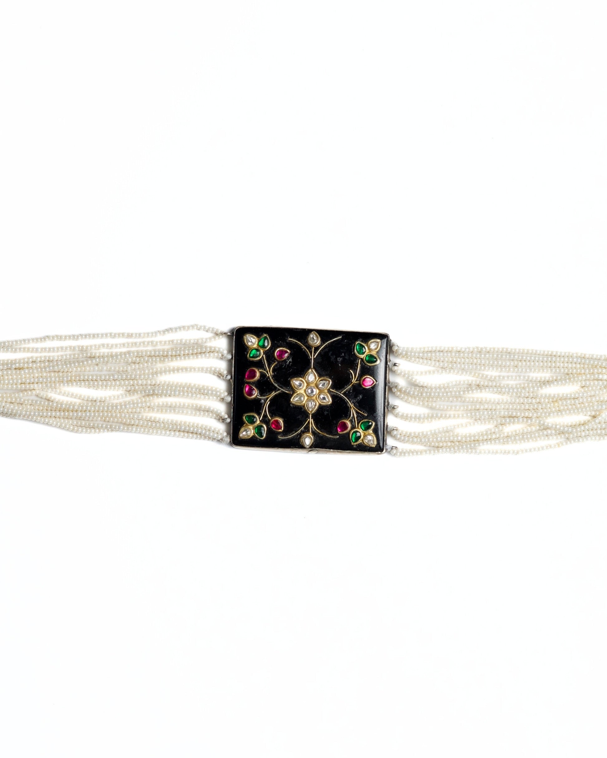 Black enamel floral choker in 925 silver with kundan-style stones, ruby and emerald accents, and multi-strand pearl detailing.