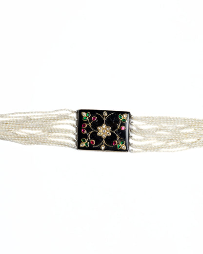 Black enamel floral choker in 925 silver with kundan-style stones, ruby and emerald accents, and multi-strand pearl detailing.
