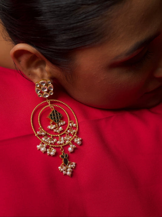 Handcrafted 925 silver hoop earrings with double gold-toned rings, kundan top, pearl clusters, and black enamel charms – fusion Indian jewellery design.