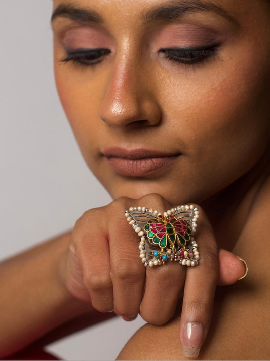 Butterfly-shaped fusion ring in 92.5 silver with meenakari enamel work, pearl edges, and multicolored bead tassels