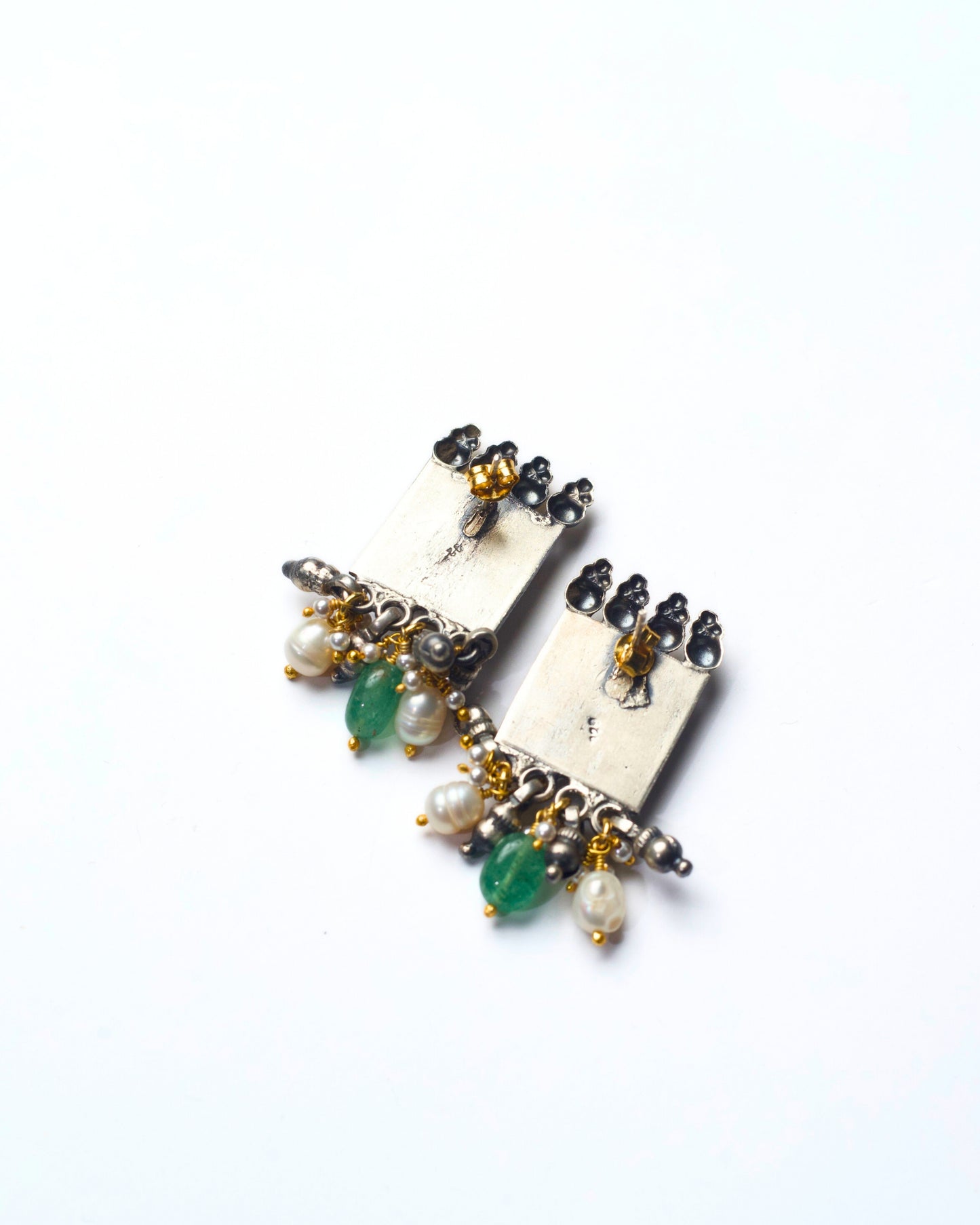 Back shot of Square framed fusion silver stud earrings in 925 silver with deep red stone, pearl detailing, oxidised finish, and subtle gold-polished accents.