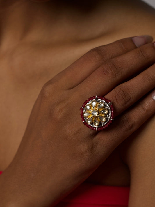 Close-up of The Amar Phool Ring handcrafted in 92.5 silver with golden kundan floral center and red beads detailing